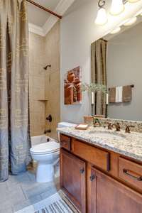 This main level secondary bath is located between the den and the guest bedroom and also serves as a "powder" room.