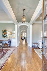 Such an impressively welcoming foyer complete with a barreled ceiling and doorway. To the right is the den/sitting/music room; to the left is the dining room/office.