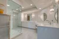 The primary ensuite bathroom has excellent lighting with crystalline accents and recessed lights.