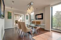 The formal dining room is accented with a crystalline chandelier and adjustable lighting to set the perfect tone.