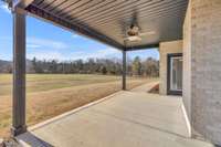 Covered back patio with a ceiling fan overlooking this beautiful property! 9998 Big Springs Rd  Christiana, TN 37037