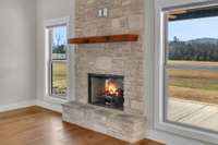 This gas fireplace with extra large mantle and impressive stone work is the focal point of this living space! Lots of windows for natural light to pour through! 9998 Big Springs Rd  Christiana, TN 37037 (virtually staged)