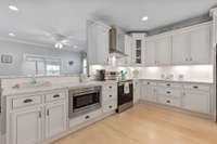 This kitchen is immaculate with a full rangehood, prestine white cabinetry and recessed lighting! 2445 Taylor Ln  Eagleville, TN 37060