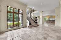 The grand staircase is a show stopper. Wrought iron panels from the original home on this site have been incorporated into the railing.