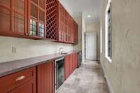 A butlers pantry connects the dining room and kitchen. Also in this area is a large pantry with another sink.