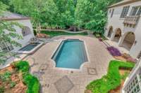 Look at this stunning backyard complete with mature landscaping. This yard has a pool, spa, koi pond, full pool bath and covered sitting area with a fireplace.