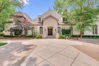 The house has a horseshoe driveway with lots of parking and garages. The right side of the home has a 3 car-garage and the left side has a 2-car garage.