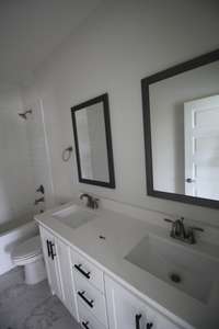 Downstairs bathroom has a double vanity and tile floors!