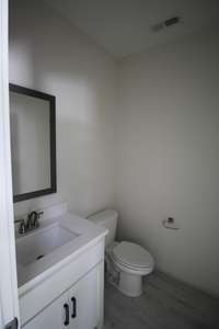 Half bath with tile floors and quartz counter tops!