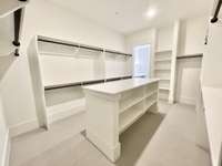 Abundant Storage in the Primary Bedroom Closet with Built In Island!