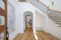 Step into this inviting entry foyer, where graceful arched doorways lend an air of elegance and charm to the space.