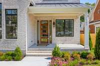 A charming covered front porch adds to the home's curb appeal, providing a perfect spot for relaxation.