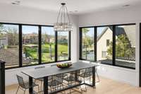 Eye-catching Restoration Hardware light pendant over large designer dining table.