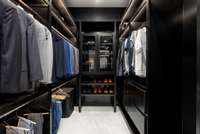 Convenient storage for all of your shoes and bags enclosed with glass cabinetry for protection.