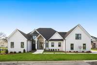 Artfully built by Botsko Builders, the exterior showcases meticulous craftmanship with a blend of stucco and brick