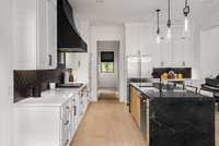 Stunning quartz countertop waterfall island with custom lighting under all cabinets