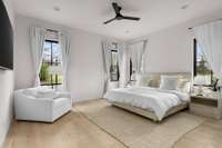 Expansive front bedroom with large windows throughout filling the room with sunlight throughout the day.