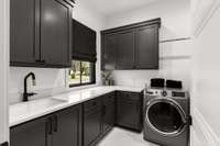 Full laundry room with custom built cabinetry.