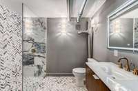 Marble guest bath on the ground level with large walk in shower