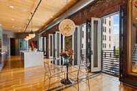 We continue into a warm and dramatic living space where soaring 14-foot ceilings meet five 9-foot French door Juliette balconies.