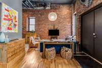 The 1200 sq ft guest house can be used for retail, commercial or AirBnB. Warm, white oak floors meet the original brick walls that reach to the soaring 18' ceilings