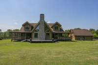 The impressive rock chimney is a showcase on the back of the house, and wrap-around porches and a back deck offer a 360 view of the beauty of the hills of Williamson County.