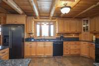 Custom solid wood kitchen cabinets are to be expected in the level of craftsmanship put into this well-built home