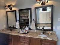 Granite countertop with 2 sinks and 3 mirrors.  So much space for all of your bathroom stuff.  six short drawers, 3 deep cabinets and 3 long drawers.