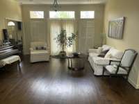 Formal living area with access to the patio and back yard.  REAL hardwood floors. Enough space to dance!  Note the updated floor boards throughout most of the house.