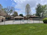 Pool has gazebo area if you want to come to the pool and not sit in the sun.  Party area to the right with grills and tables under a roof with access to the pool that residents can reserve for parties.