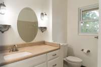 Full bathroom with tub/shower combination with updated fixtures and fresh tile flooring.