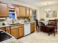 Nice eat-in kitchen with oak cabinets granite countertops and tile backsplash; New Bosch dishwasher, electric stove and refrigerator;