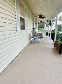 Sit on the long front porch with ceiling fan & NO STEPS!