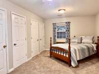 12x18 Primary Bedroom with carpet and 2 separate closets with full bath with fiberglass shower, vanity and 2 separate closets