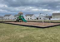 Playground surrounded by greenspace.