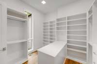 Walk in closet with packing table and tons of storage