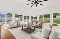 Directly off the kitchen, this sunroom is everything. There is tons of natural light from three walls of windows.