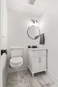 The lower level half bath off the bonus space shows some style.