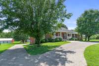 Circle driveway that also leads to the built in garage and attached carport.