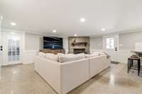 Den area in finished basement with gas fireplace.