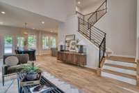 A gracious switchback staircase anchors the Living Space and is highlighted by the custom railings.