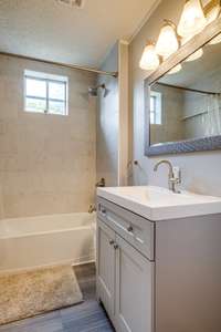 Second half of the bath upstairs with tiled shower and updated vanity!