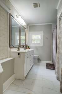 Beautiful tiled primary bath with double vanities!