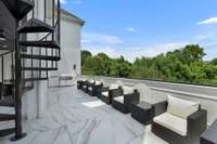 Entertaining deck off basement level. Spiral stairs to sun room/kitchen.