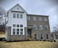 The home faces the Bio-Retention Pond with Landscaping... NO homes being built across the street! Sidewalks on BOTH SIDES of the street! A MASSIVE STORAGE area behind the garage which houses your TANKLESS HOT WATER HEATER!