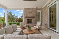 Resort-style covered outdoor living area with fireplace and outdoor kitchen overlooking fabulous Pool / Spa.