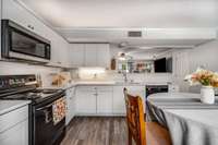 Black and stainless appliances match perfectly with cabinets, counters, flooring, and paint!