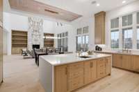 View of Gourmet Kitchen with stained white oak cabinets and water fall oversized island with extra storage.