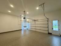 Bright and spacious4 - car garage to store your cars, tools and toys.  Epoxy flooring, high ceilings plenty of space for car lifts, wall storage, cabinets, side and rear pedestrian doors.