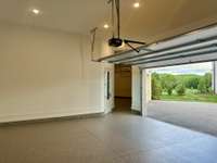 Bright and spacious4 - car garage to store your cars, tools and toys.  Epoxy flooring, high ceilings plenty of space for car lifts, wall storage, cabinets, side and rear pedestrian doors.